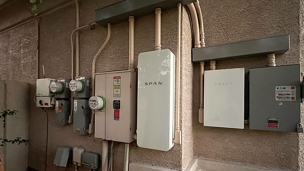 A smart panel (SPAN panel) and multiple meters installed on an electrical service entrance in Phoenix, AZ