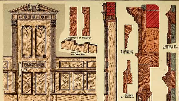 An interior doorway framed in dado carpentry and joinery, standing open onto the room beyond it