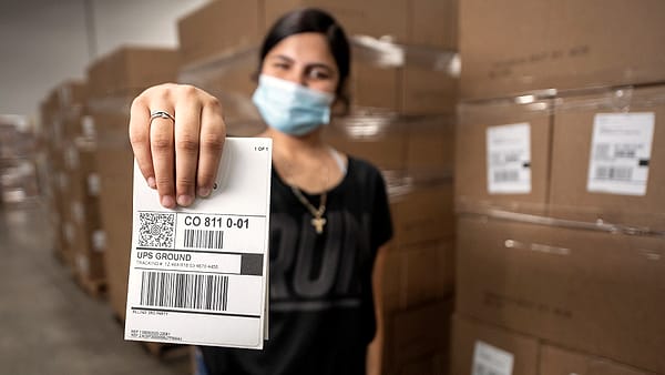 Professional Packaging Systems Quality Packaging (Qual Pac) Labeler Charon Lopez shows a sample label that will route food