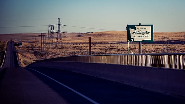 A welcome to Washington state sign on I-82 between Umatilla, Oregon and Plymouth, Benton County, Washington on the