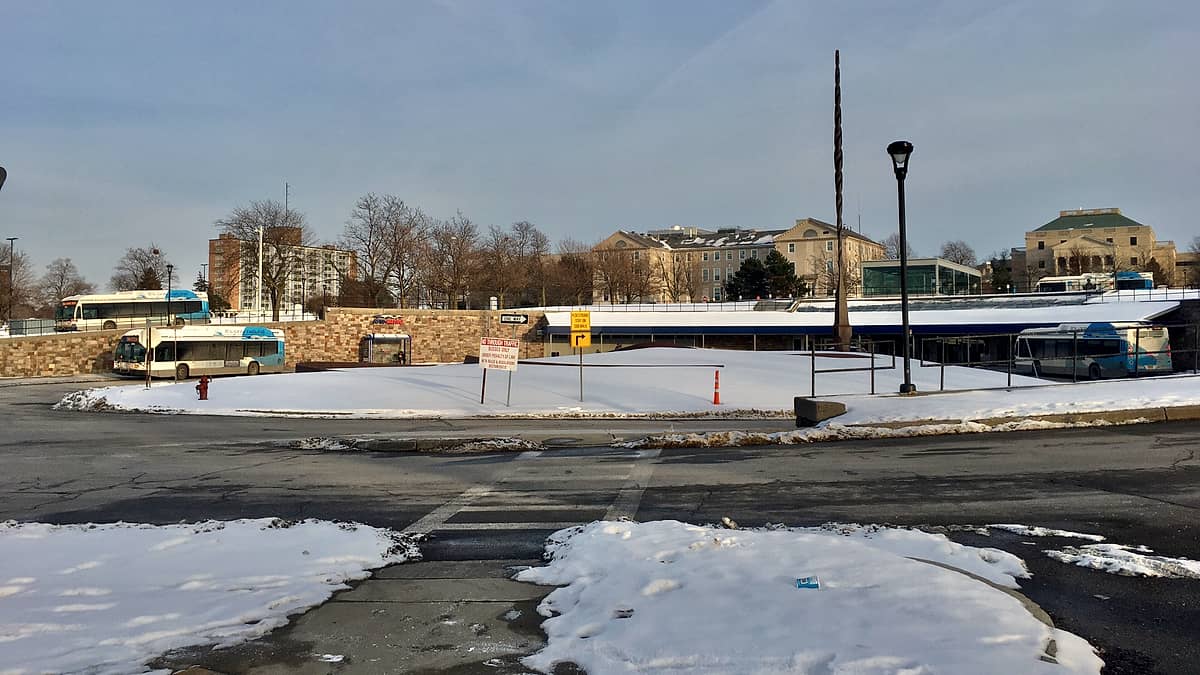 The exterior of the NFTA Metro Rails University Station, showing the bus loop and the 150-foot needlelike sculpture ( Vertical