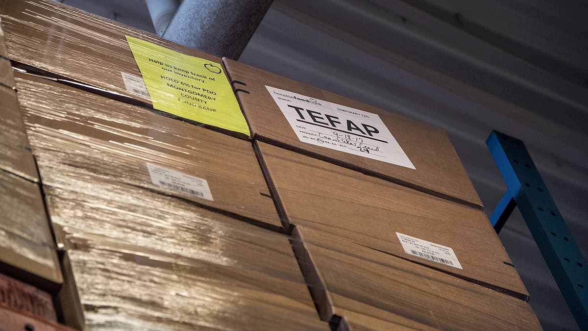 Pallets of USDA Emergency Food Assistance Program (TEFAP) commodities are shelved to the ceiling, on the Houston Food Bank
