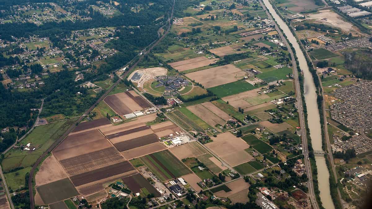 Puyallup, WA. 5625 52nd Street East. School Administration is circular structure in center, surrounded by farms, with the Puyallup River